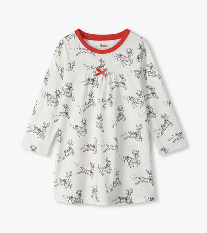 Girls white long-sleeve nightdress with leaping reindeer print, red neckline, and red bow at the chest