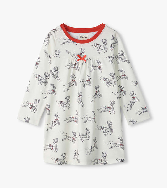 Girls white long-sleeve nightdress with leaping reindeer print, red neckline, and red bow at the chest