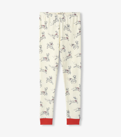 Girls cream pajama pants with leaping reindeer print and red ankle cuffs