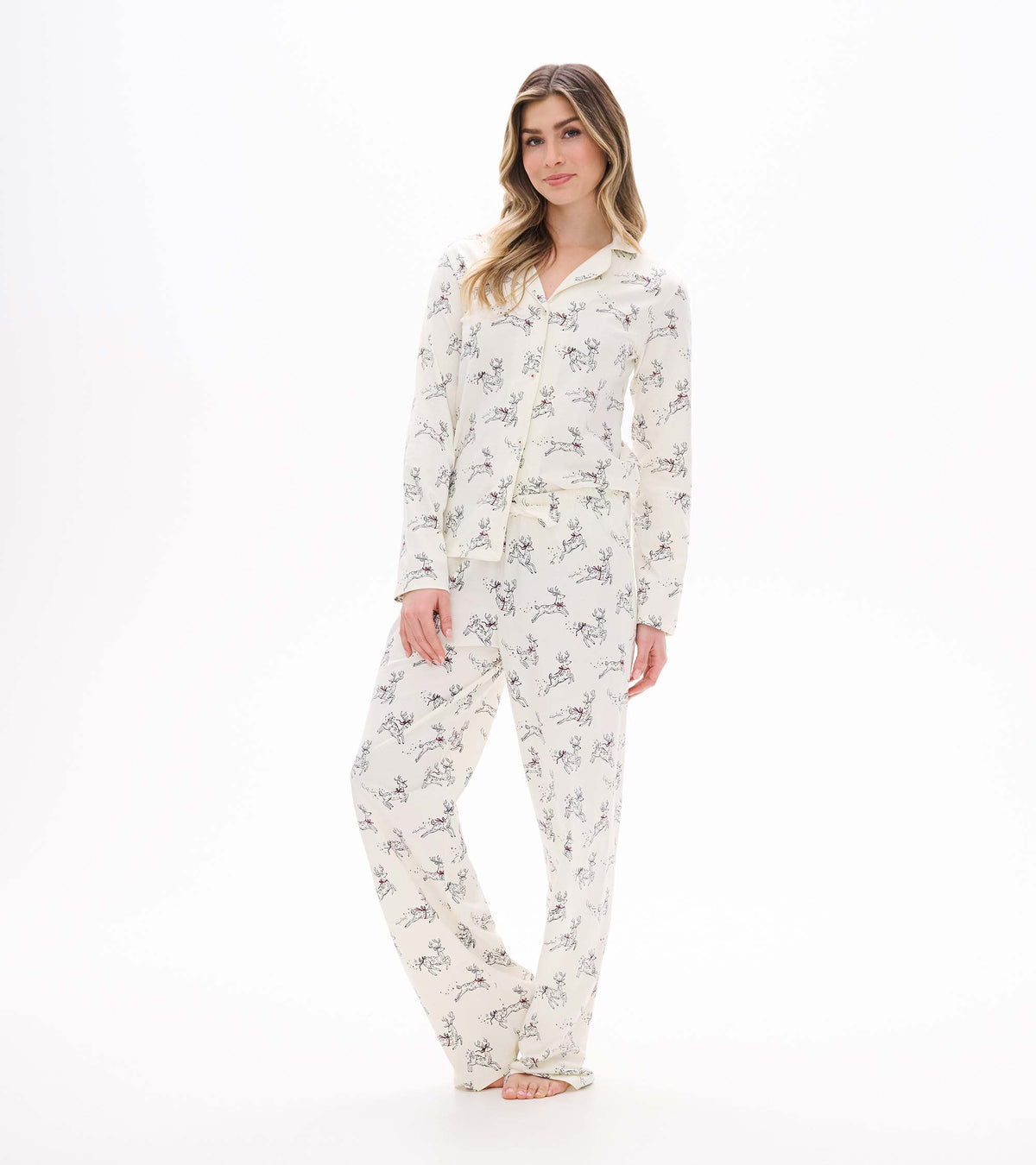 Front view of cream button-up pajama set with long sleeves and scattered prancing reindeer print