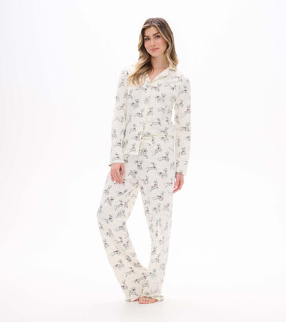 Front view of cream button-up pajama set with long sleeves and scattered prancing reindeer print