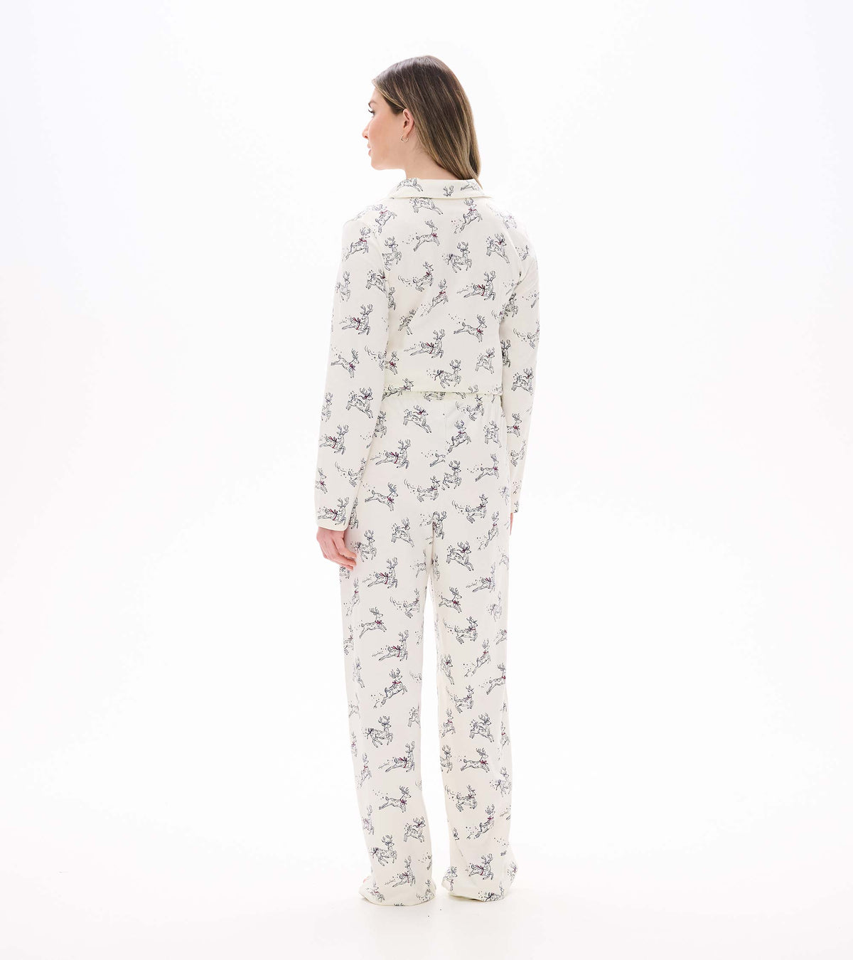 Back view of cream pajama set with long sleeves and scattered prancing reindeer print