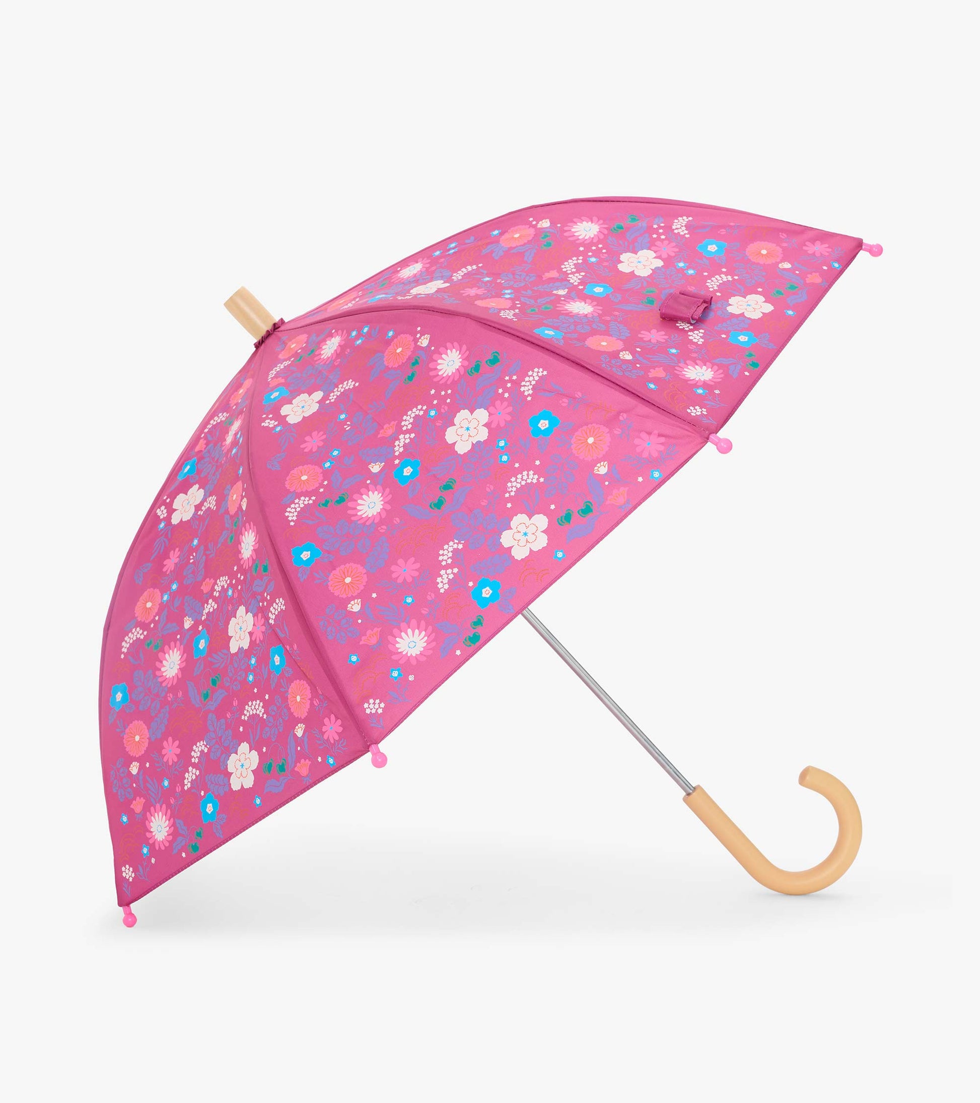 Open pink kids umbrella with tiny floral print and curved pale wood-look handle