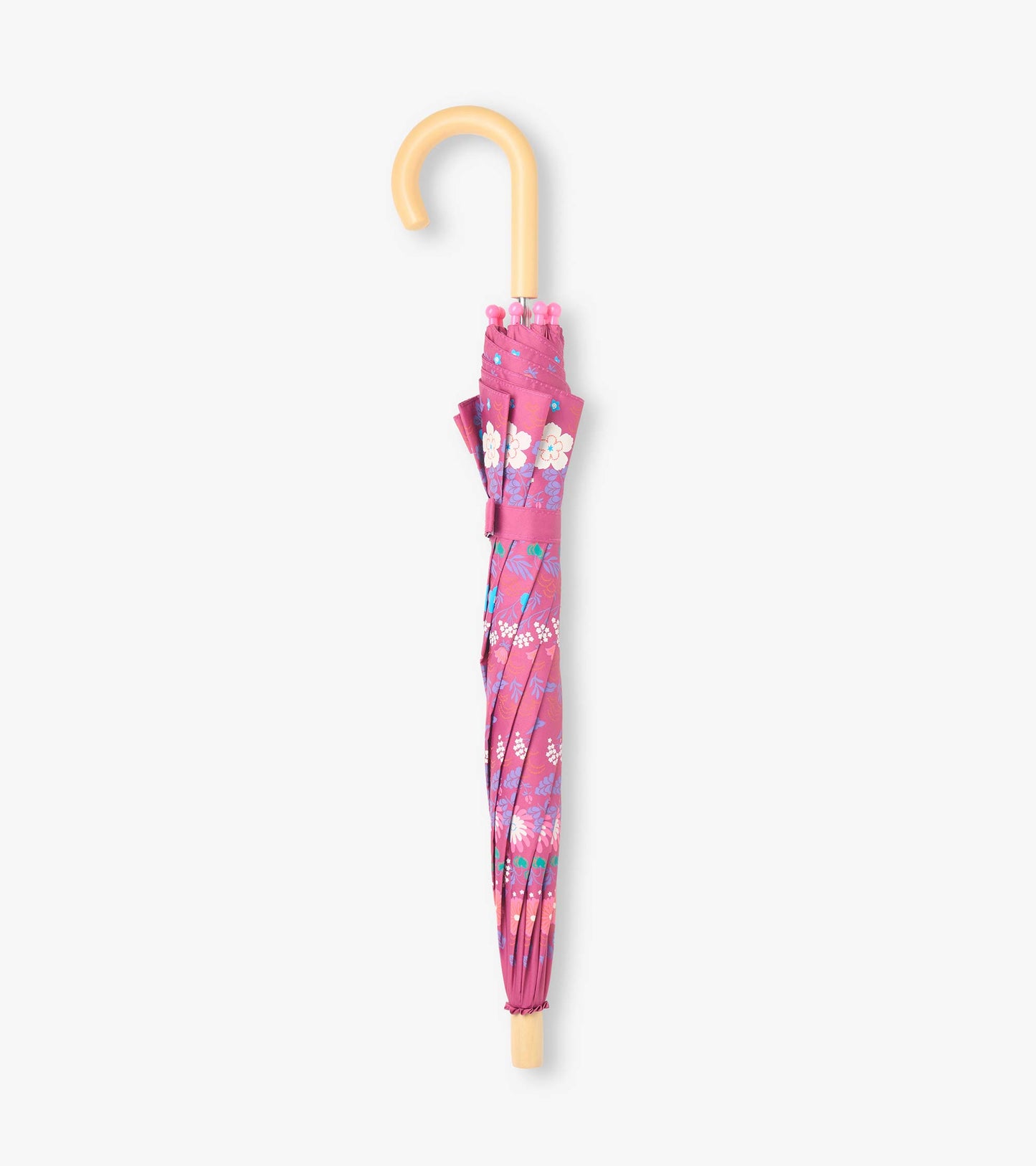 Closed pink floral kids umbrella with matching wrap strap and curved pale wood-look handle