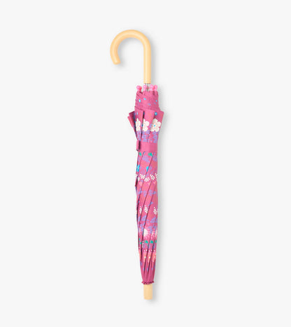 Closed pink floral kids umbrella with matching wrap strap and curved pale wood-look handle