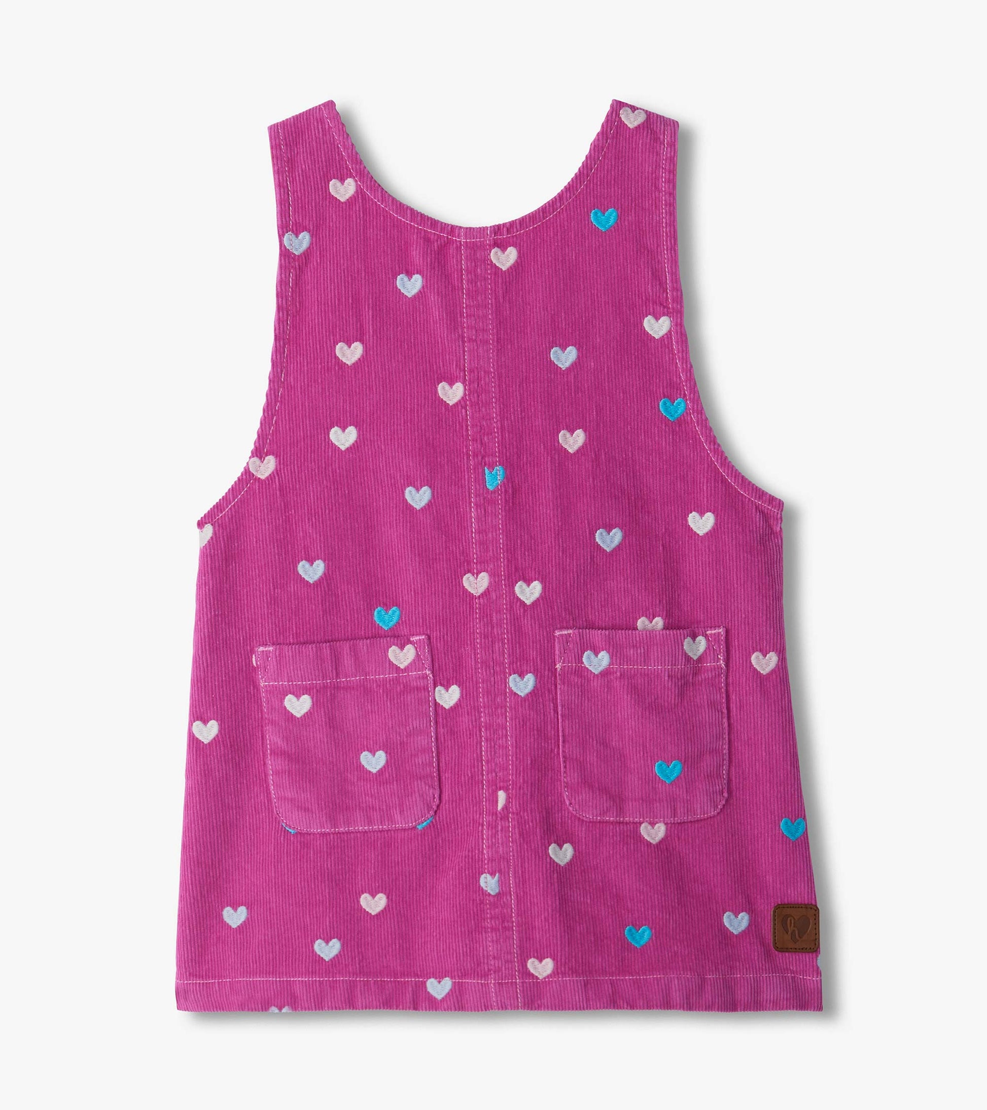 Front of pink pinafore dress with embroidered hearts, scoop neck, two front pockets, and center seam
