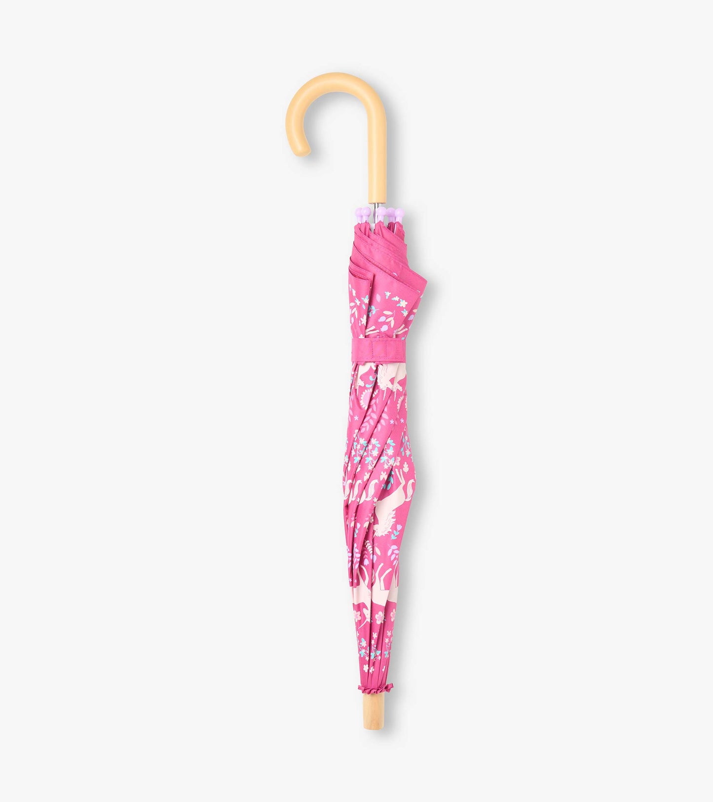 Closed pink unicorn print umbrella with curved light wood-look handle and matching wrap strap
