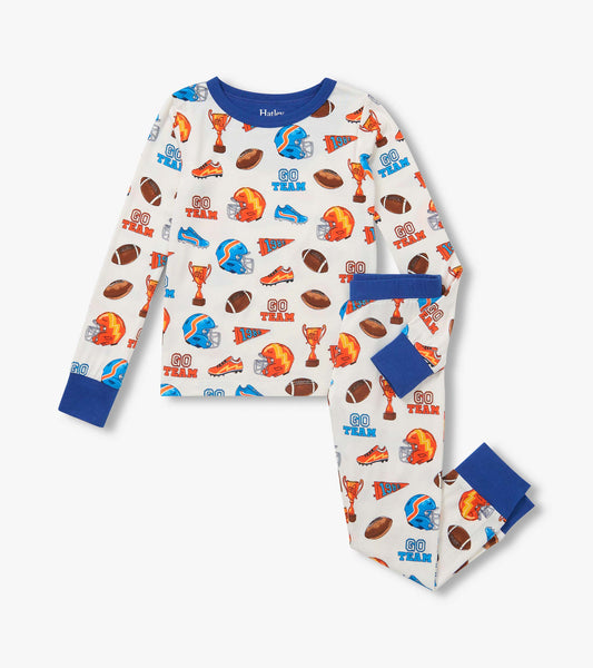 Kids pajama set with blue trim and sports print featuring footballs, helmets, trophies, cleats, and 'Go Team