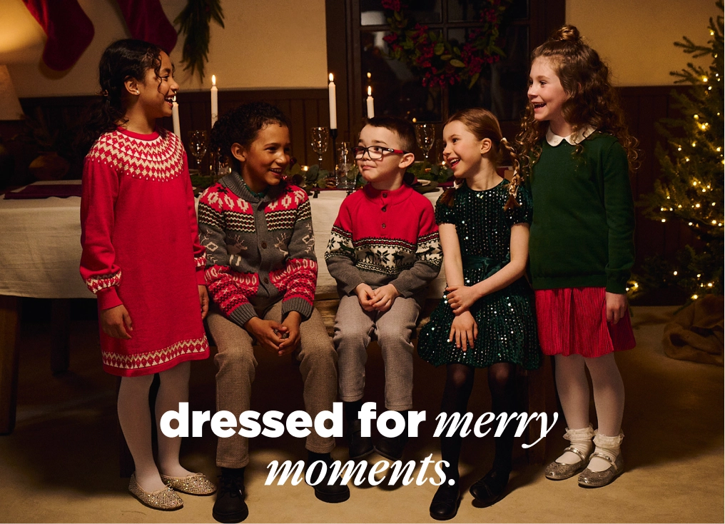 Promotes kids' holiday daywear collection. With "dressed for merry moments." text.