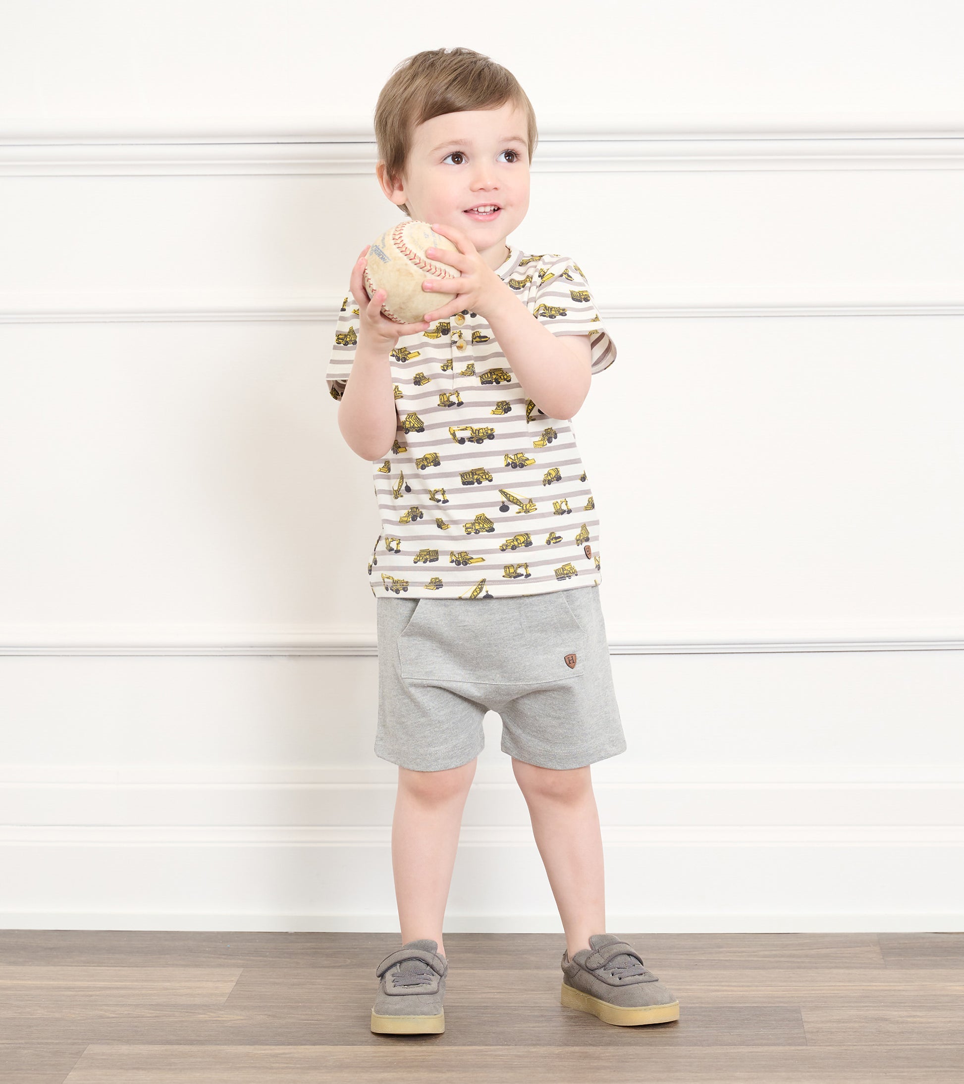 Grey toddler athletic shorts with elastic waistband, shown on a child model, front view