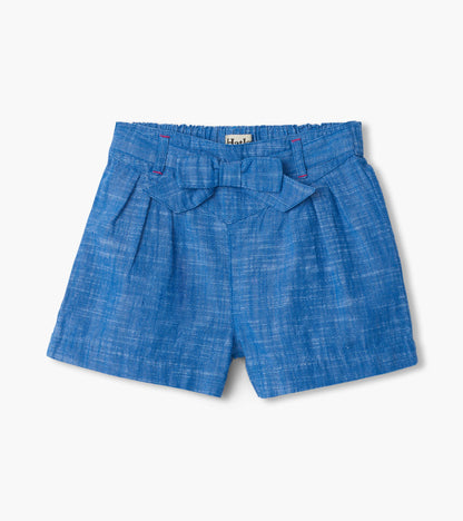 Blue chambray girls shorts with paper bag waist and bow detail, front view
