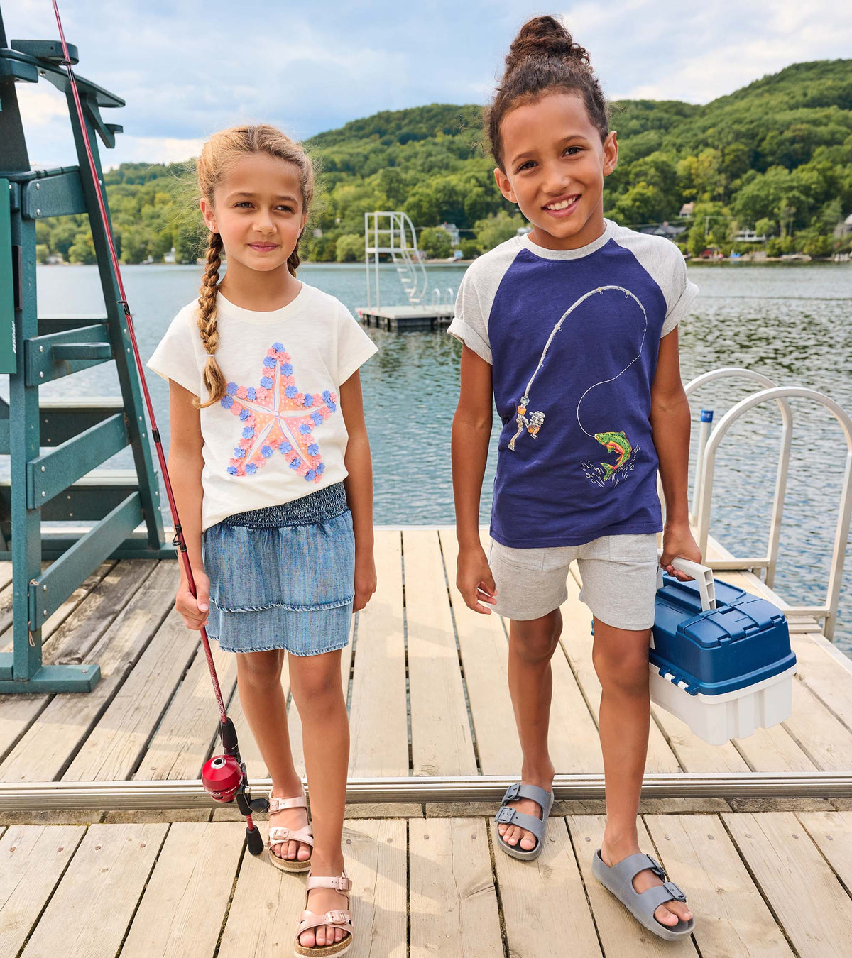 Blue denim smocked girls skirt with tiered hem, shown on a child outdoors by the water