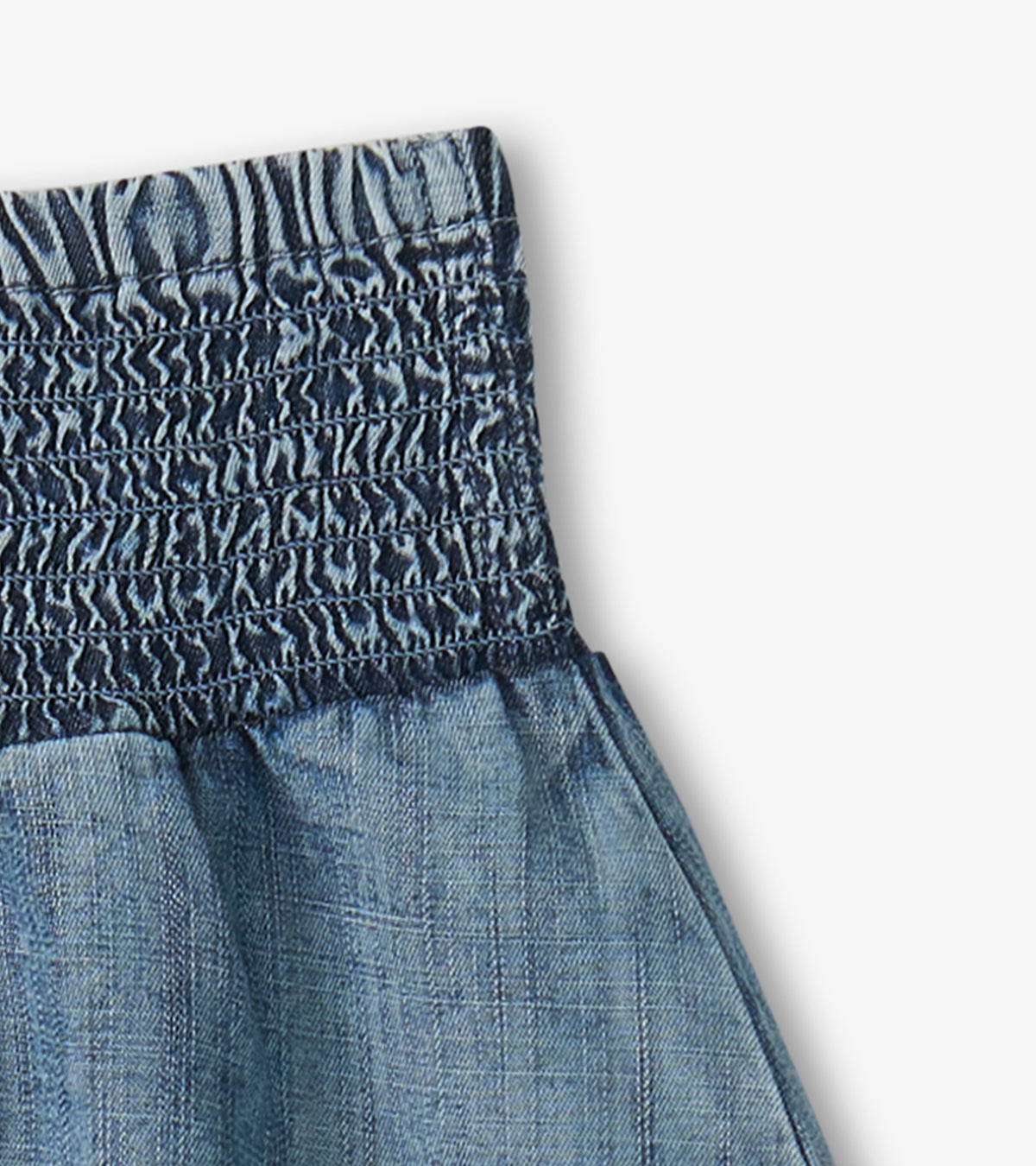Blue denim girls skirt with smocked waistband and gathered fabric detail
