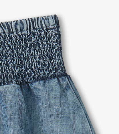 Blue denim girls skirt with smocked waistband and gathered fabric detail
