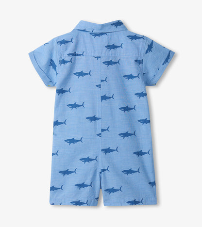 Light blue short-sleeve baby romper with dark blue shark print, shown from the back.