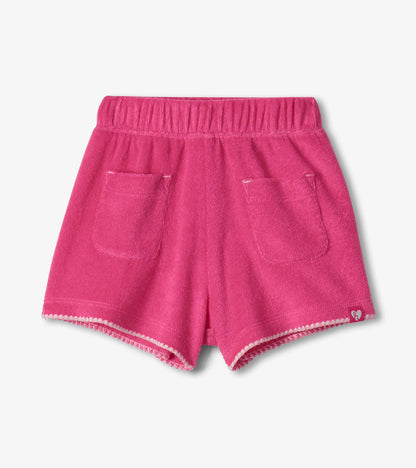 Pink toddler shorts with elastic waistband, front pockets, and scalloped hem, front view