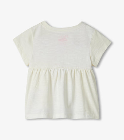 Cream short-sleeve toddler dress with gathered waist and faint pink flamingo print on back