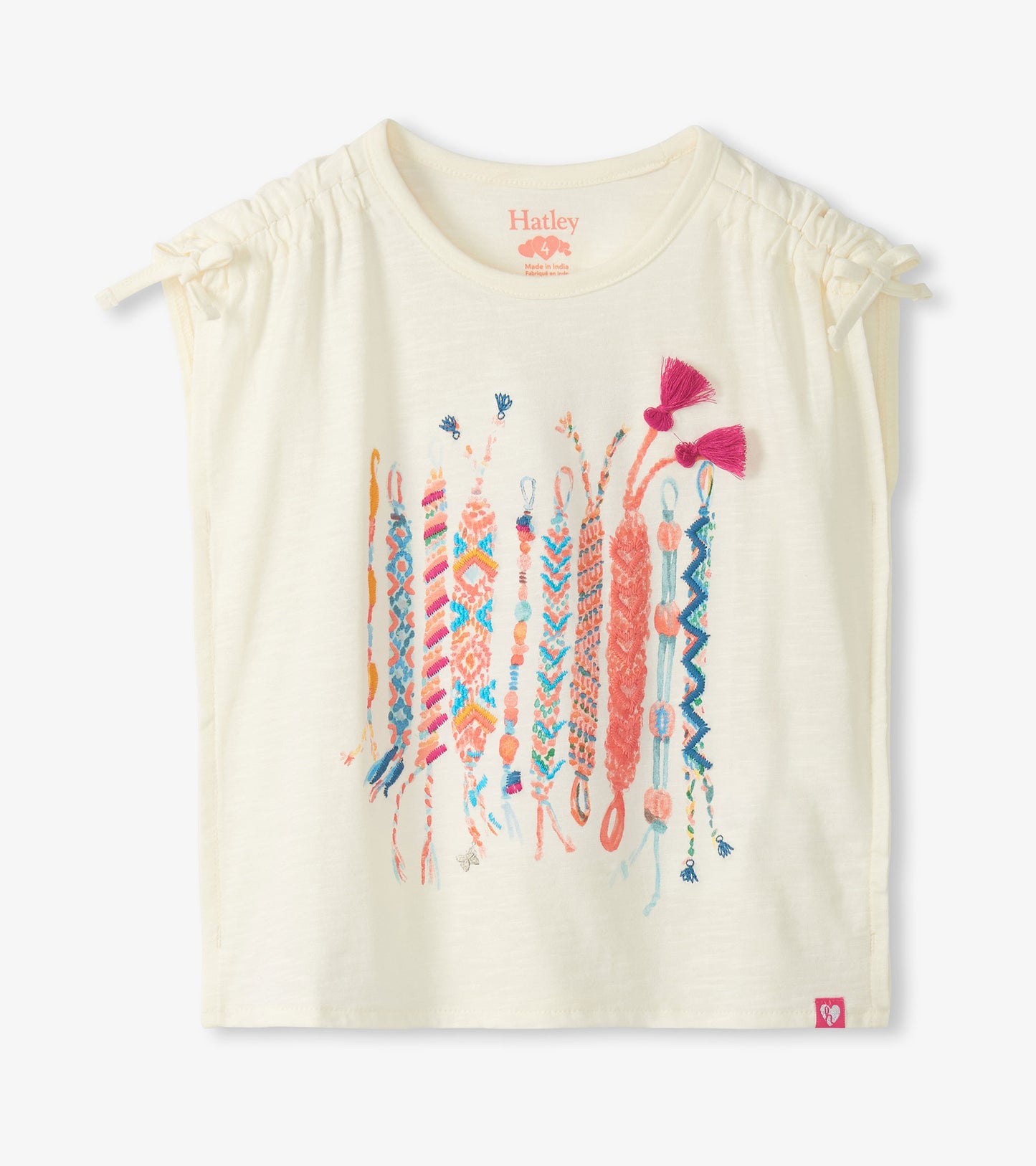 Cream girls top with cinched shoulders and colorful friendship bracelet graphic, front view