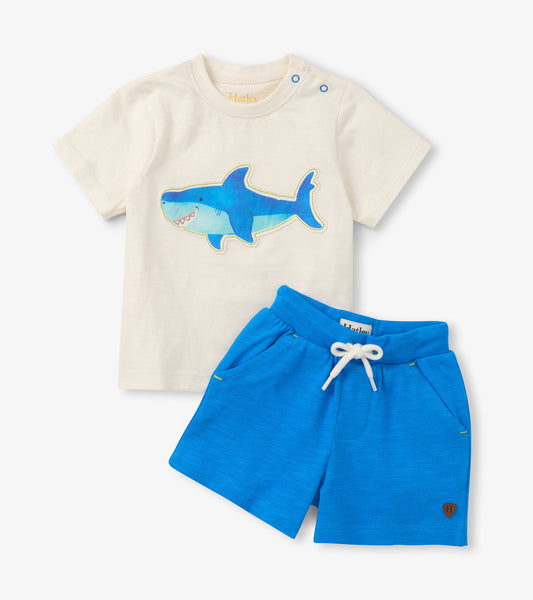 Cream short-sleeve T-shirt with blue shark graphic and bright blue drawstring shorts, front view