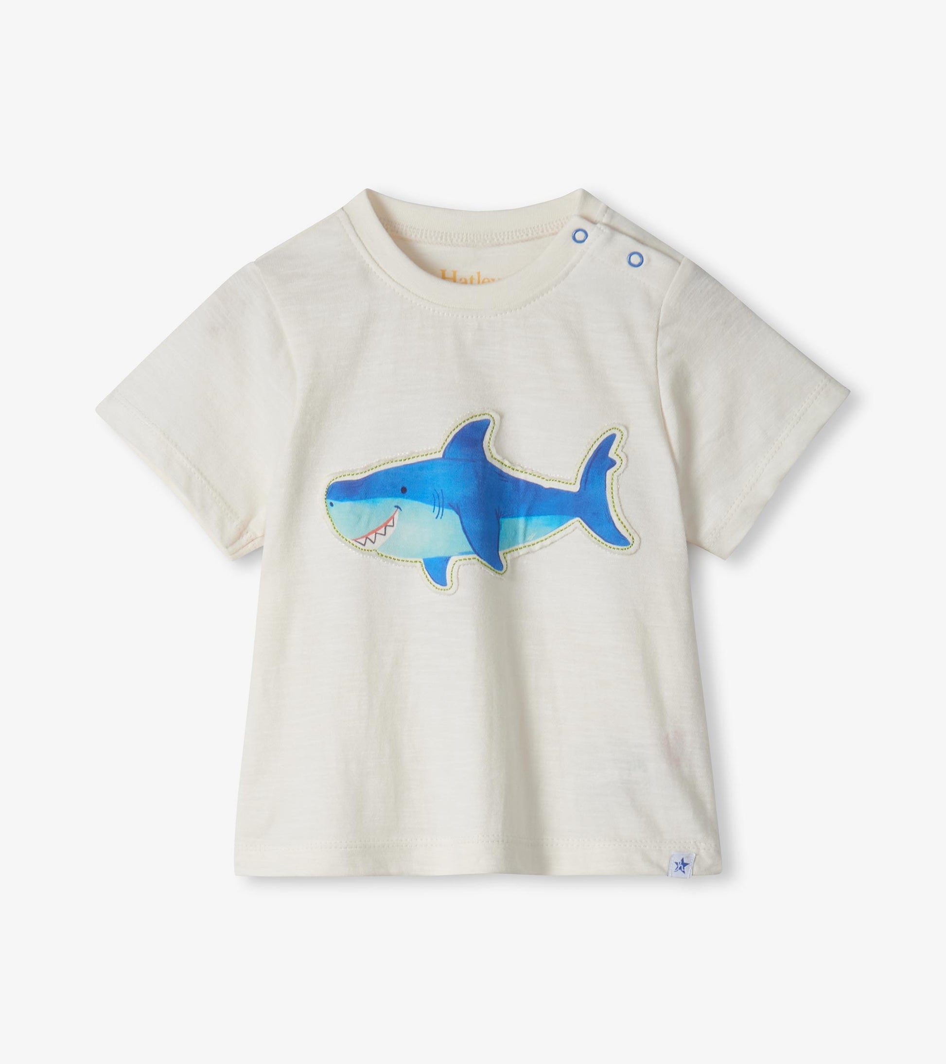 Cream short-sleeve toddler T-shirt with blue shark graphic and shoulder snaps, front view