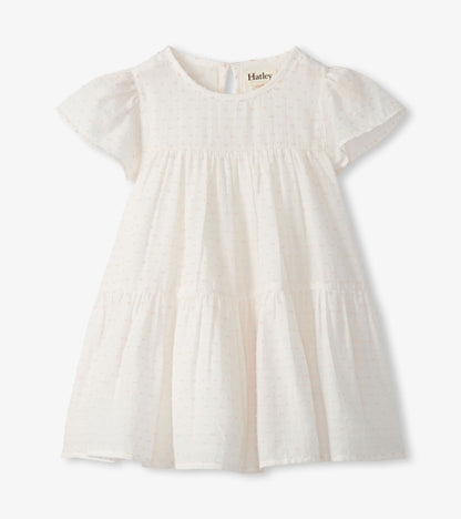 Front view of pearl Swiss dot toddler dress with short puff sleeves, round neck, and tiered skirt