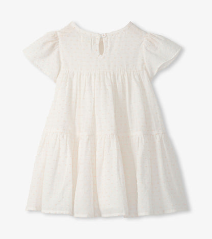 Back view of pearl Swiss dot toddler dress with keyhole button closure and tiered skirt
