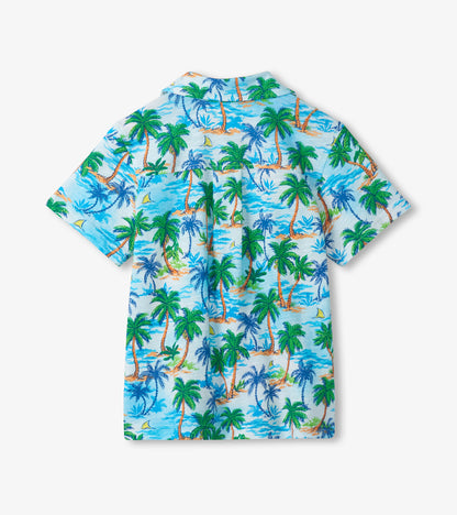 Light blue boys button-down shirt with tropical palm tree print, short sleeves, back view