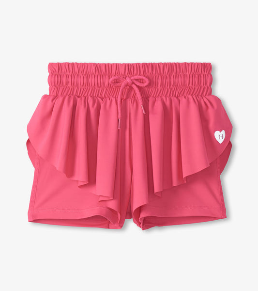 Pink girls running shorts with elastic waistband, drawstring, and layered ruffle front detail