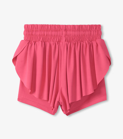Pink girls running shorts with a smocked waistband and layered ruffle front, front view