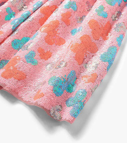 Pink sequin skirt with multicolor butterfly pattern, shown in a close-up folded view