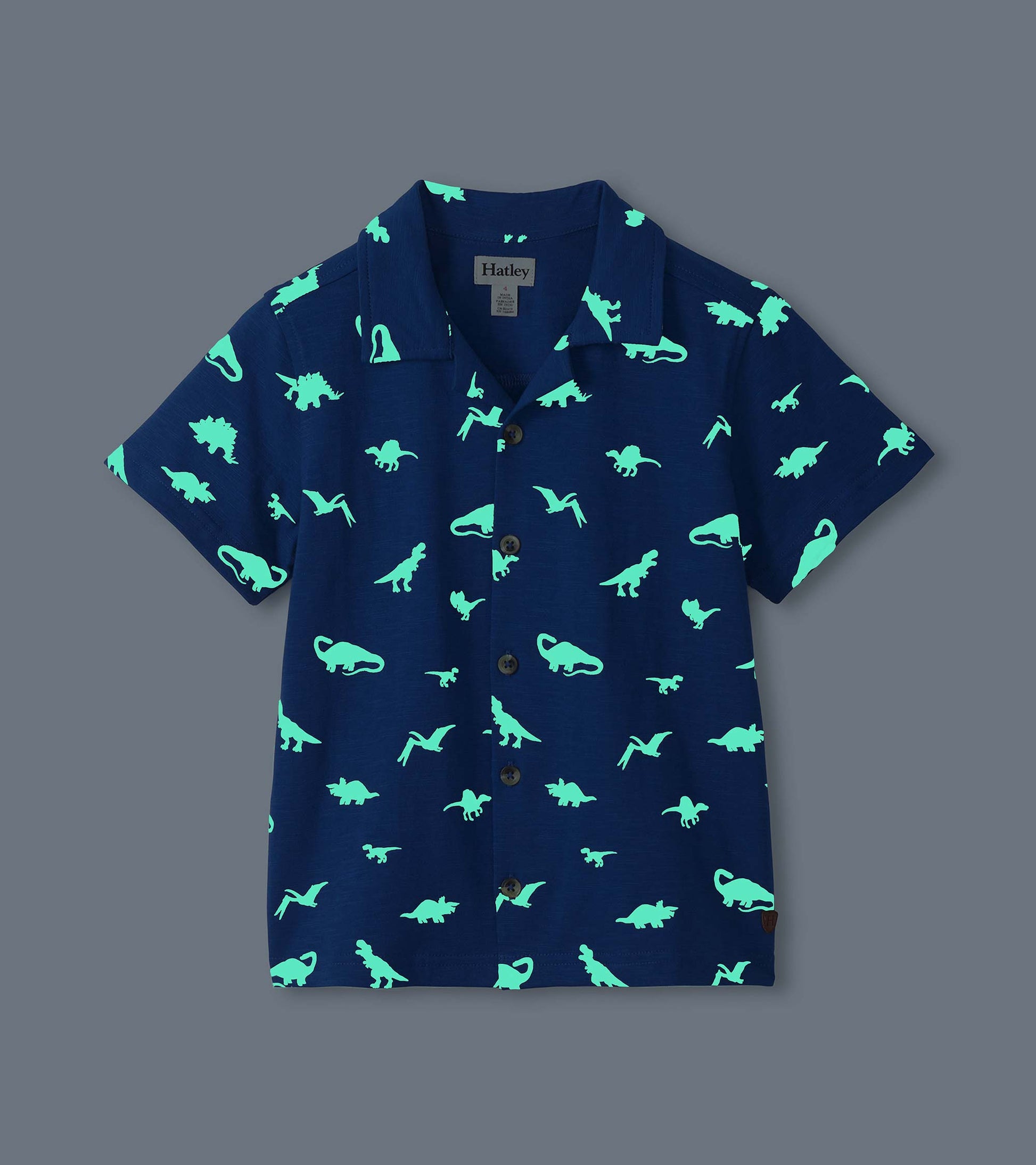 Navy short-sleeve button-down shirt with glowing turquoise dinosaur print, front view