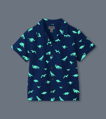 Navy short-sleeve button-down shirt with glowing turquoise dinosaur print, front view