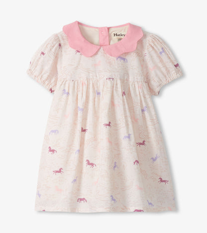 Cream toddler dress with pink collar and puff sleeves, featuring a pastel pony print.