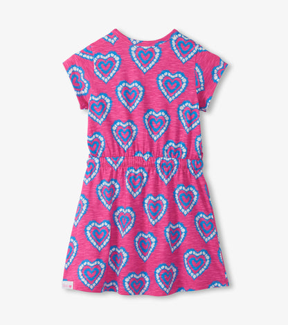Pink short-sleeve girls dress with blue and white heart print, elastic waist, front view