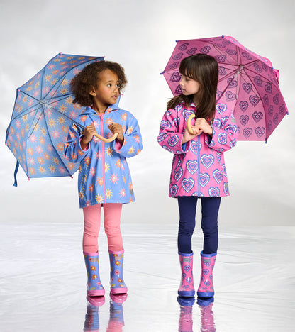 Girls zip-up raincoats with color-changing heart and sunburst prints, shown on two children holding umbrellas
