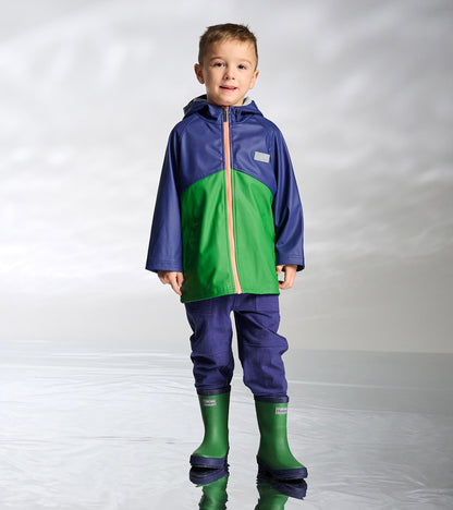 Boy wearing navy and green colorblock zip-up raincoat with hood and orange zipper, front view