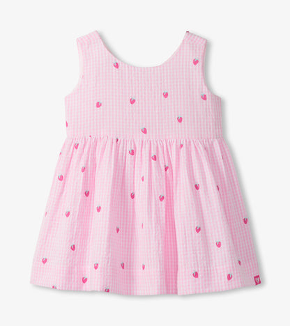 Front view of pink and white gingham sleeveless party dress with small strawberry embroidery