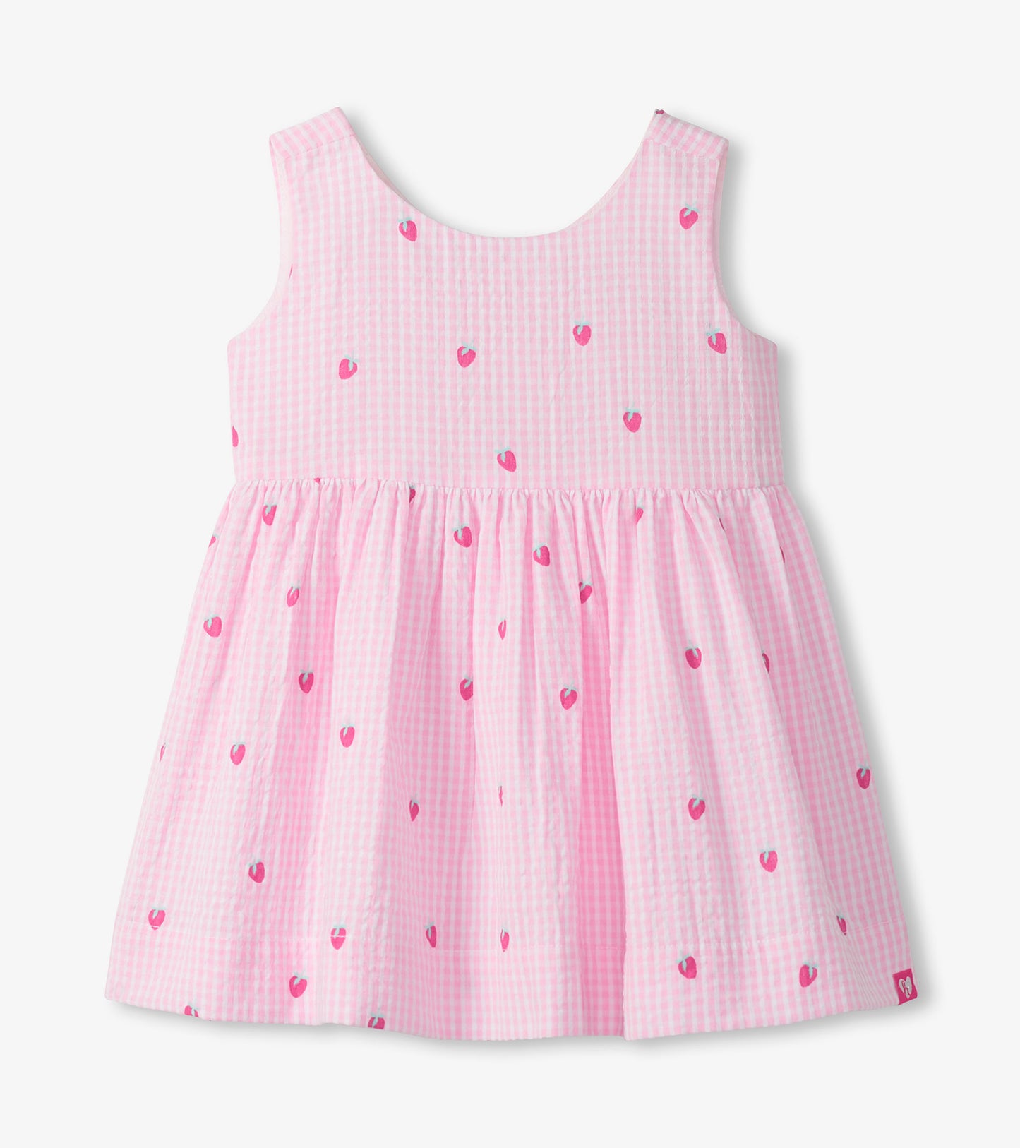 Front view of sleeveless pink gingham dress with small berry motifs and a gathered skirt