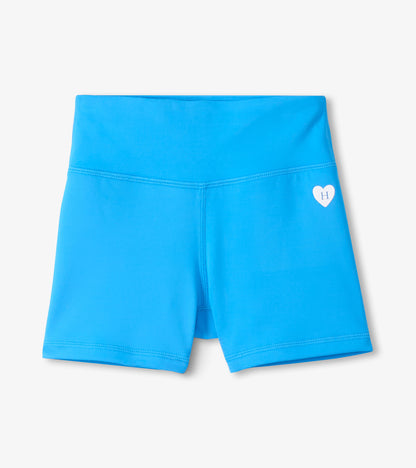Bright blue girls’ active shorts with a small heart logo on the leg, front view