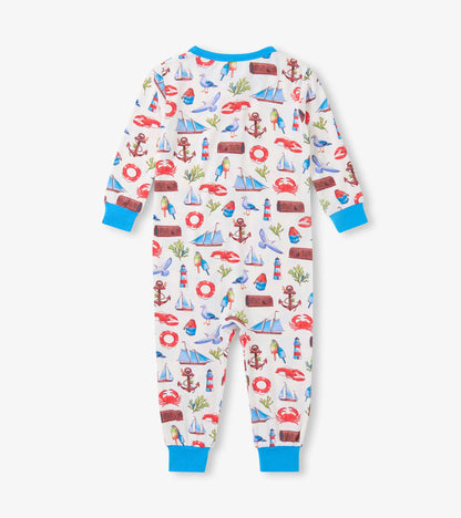 White baby sleeper with colorful seascape print, blue trim, long sleeves, and footed legs, front view