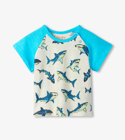 Short-sleeve raglan T-shirt with turquoise sleeves and cream body, covered in blue shark print, front view