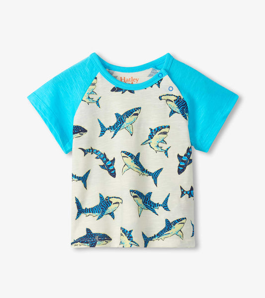 Short-sleeve raglan T-shirt with turquoise sleeves and cream body, covered in blue shark print, front view