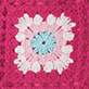 View Girls Raspberry Rose Crochet Shorts - Pink floral pattern with white and light pink petals around a blue center on a textured pink background