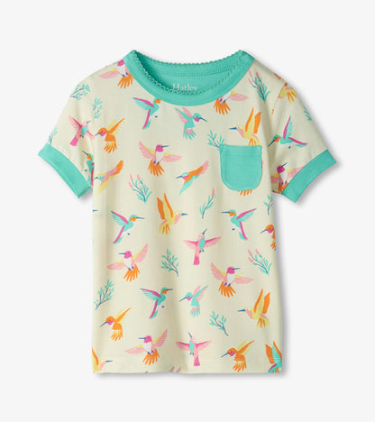 Cream short-sleeve pajama top with colorful hummingbird print, teal trim, and chest pocket, front view