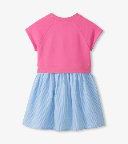 Pink short-sleeve dress with blue striped skirt and small green dot pattern, back view