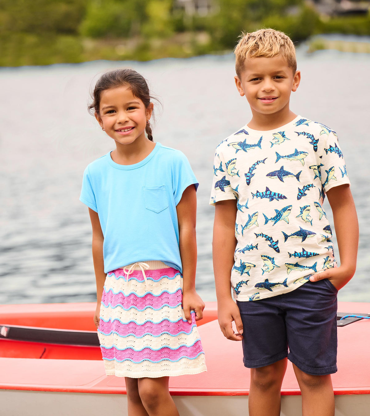 Girls crochet skirt with pink, cream, and blue wavy stripes, shown on a child standing outdoors