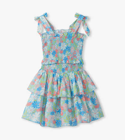 Girls blue floral smocked dress with tie shoulder straps and tiered ruffle skirt, front view