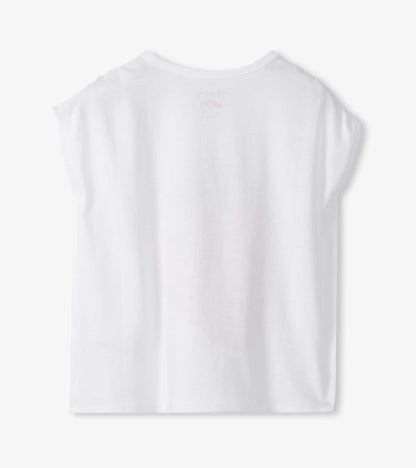 White short-sleeve girls top with cinched shoulders, back view, and faint strawberry print on the back neckline