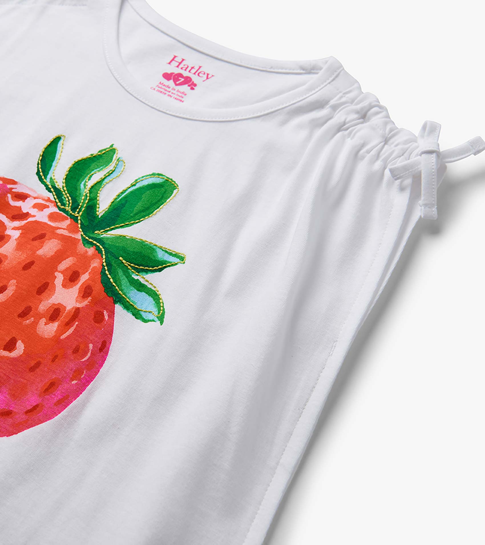 White girls top with cinched shoulder ties and large strawberry print on the front