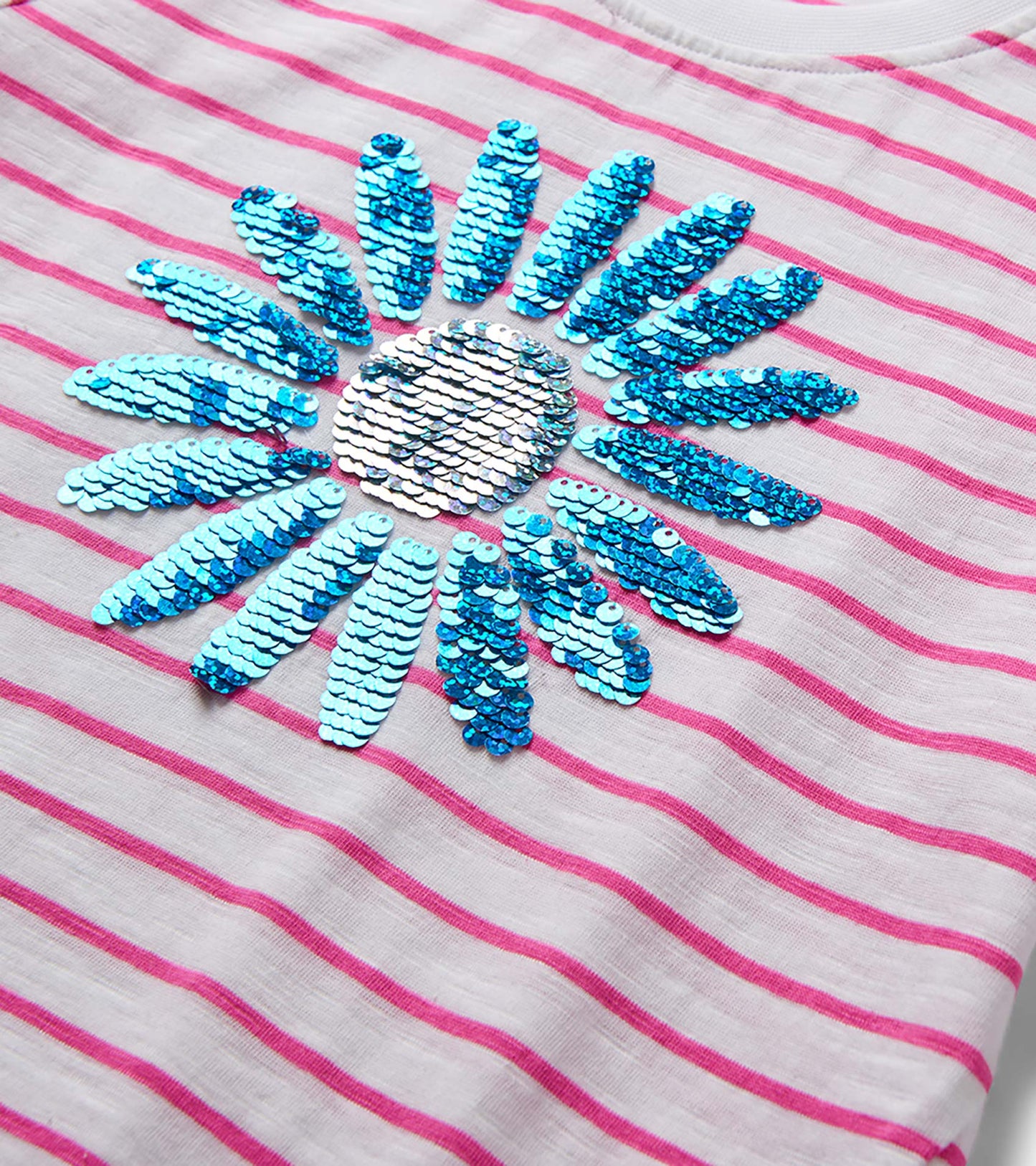 Girls white and pink striped T-shirt with blue sequin flower graphic, close-up front view